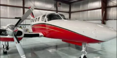 Single-engine airplane cleaned and polished inside an aircraft hangar.