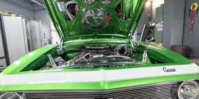 Bright green classic Chevrolet Chevelle SS with the hood open after professional detailing.