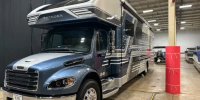 Professionally detailed RV motorhome inside a detailing facility.